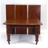 A Victorian mahogany extending dining table, with three fitted leaves, on turned legs with castors,