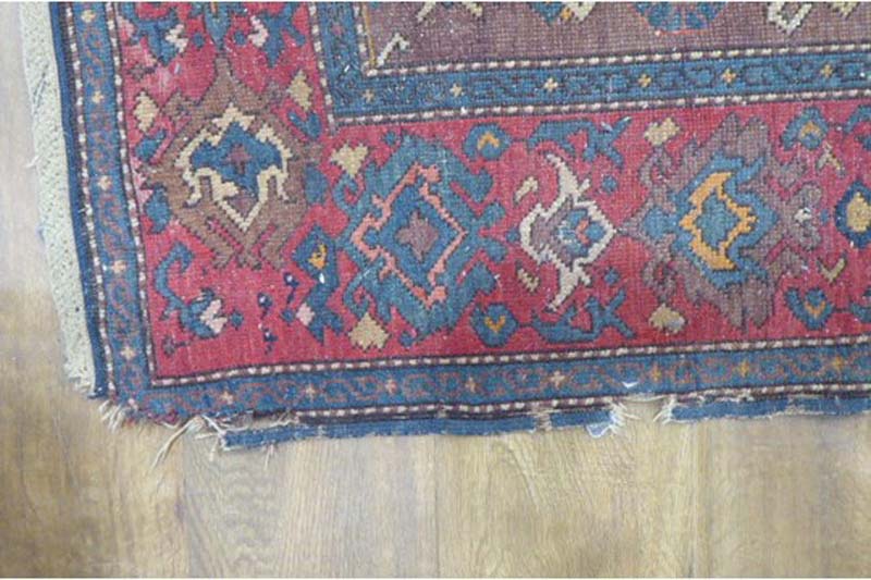 An early 20th century rug, the three medallions within a red and blue ground and matching borders, - Image 2 of 2