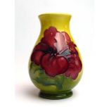 A Moorcroft miniature vase of ovoid form decorated with anemone on a shaded yellow/green ground, h.