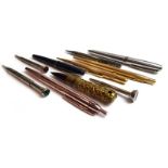 A mixed group of collectable pens and pencils including a silver propelling pencil in the form of a