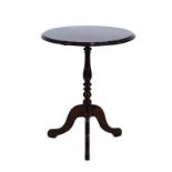 A reproduction mahogany occasional table, the circular surface on a turned column and tripod base,