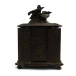 An early 20th century poker-work smoker's cabinet surmounted by a pair of birds,