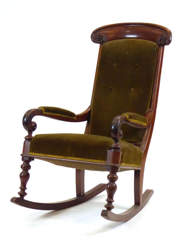 A Victorian mahogany and button upholstered rocking chair