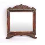 A Florentine wall mirror, the rectangular plate within a plaster and carved wooden frame,