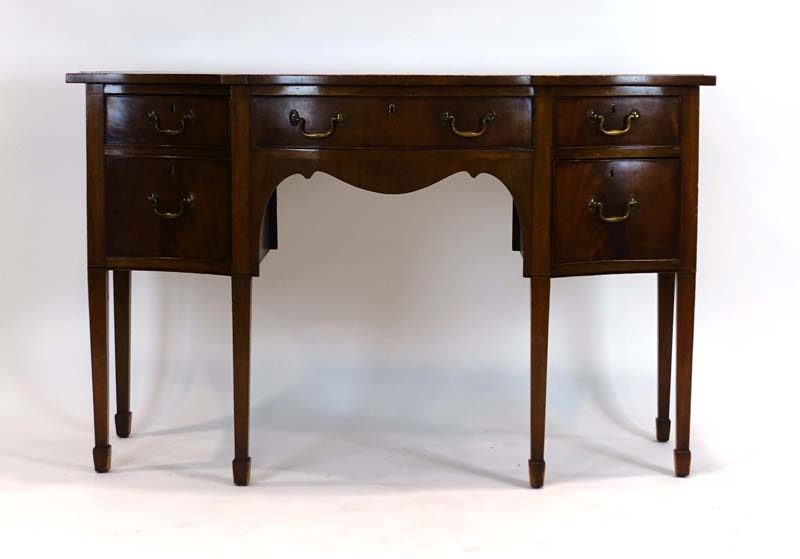 A Sheraton-style mahogany and strung serpentine fronted sideboard, on tapering legs with block feet,