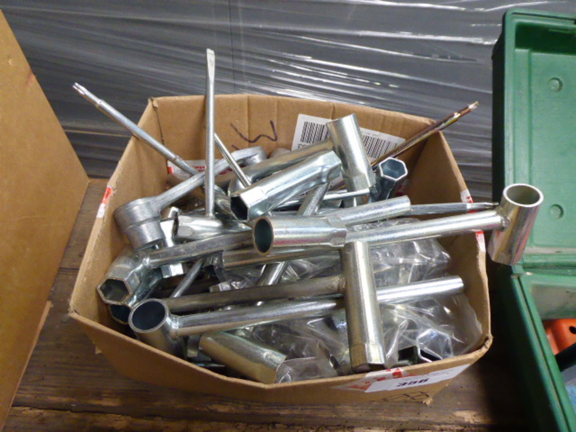 Large box of assorted universal sockets and flat head screwdrivers