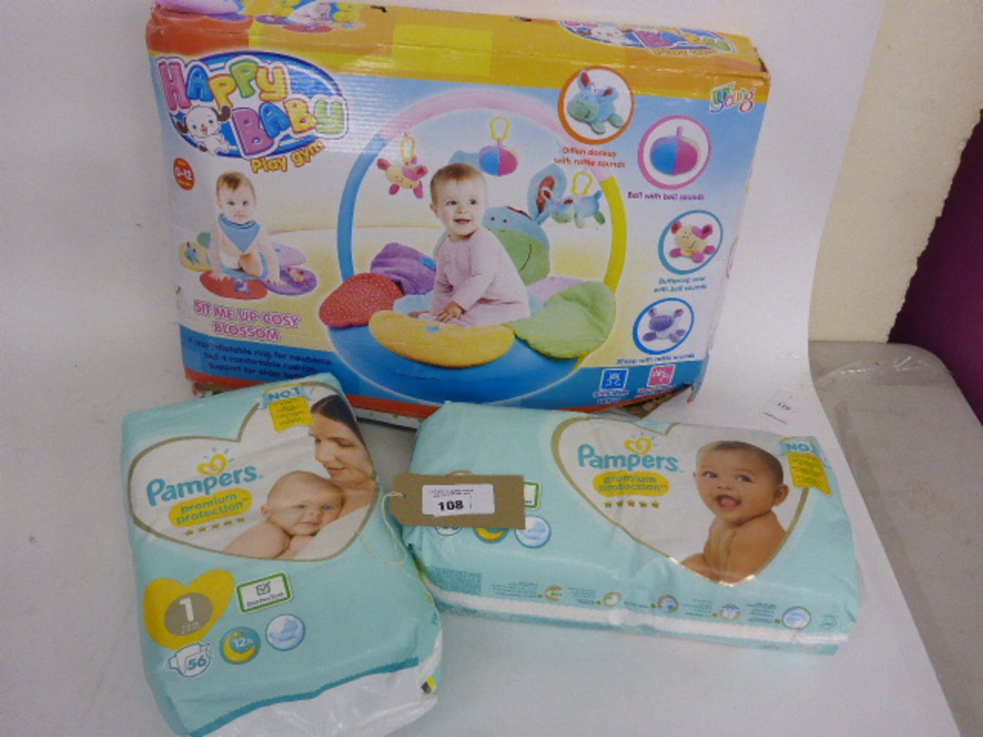 2 packs of Pampers nappies and a Happy Baby play gym