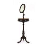 A 19th century oak gentleman's shaving stand, the circular mirror on an adjustable brass shaft,