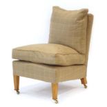 A contemporary 'Marlborough' lounge chair upholstered in caramel loosely chequered fabric,