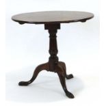 A Georgian oak tilt-top supper table,