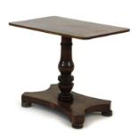 A 19th century low mahogany occasional table, the rectangular surface on a turned column,