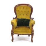 A Victorian mahogany and button upholstered armchairs on scrolled front feet