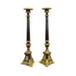 A pair of 19th century cast iron torchere stands/candlesticks, later overpainted and gilded, h.