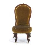 A 19th century mahogany and upholstered nursing chair CONDITION REPORT: Rickety