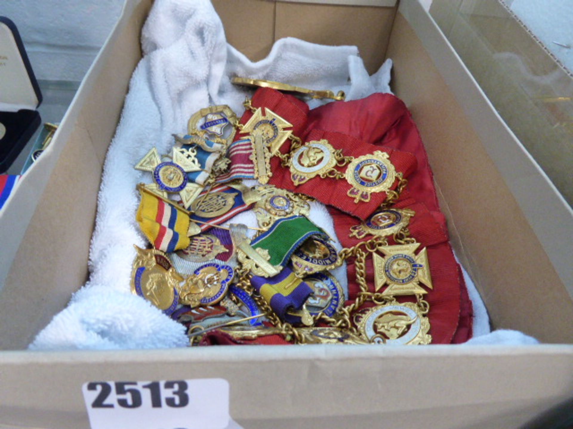 Shoebox containing various Order of the Buffalo badges, sashes and other items