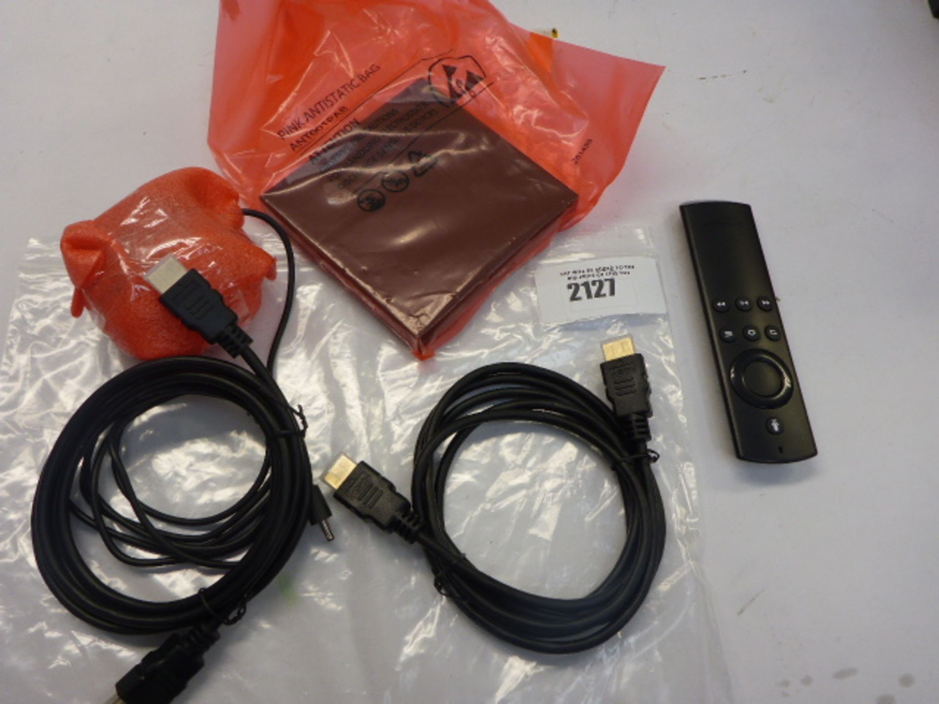 Amazon Fire TV Box with remote and cables.