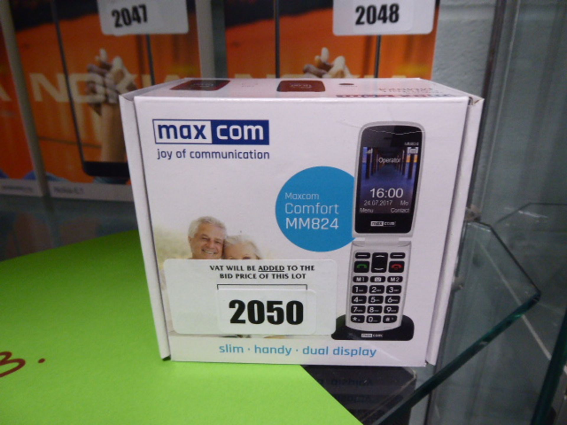 A Maxcom flip phone model MM824 with box