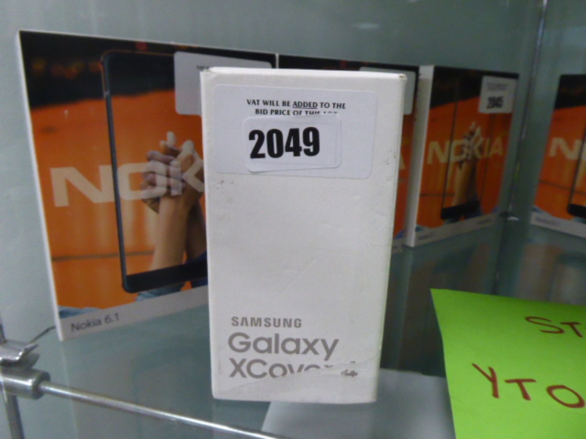 A Samsung Galaxy X cover 4 mobile with box