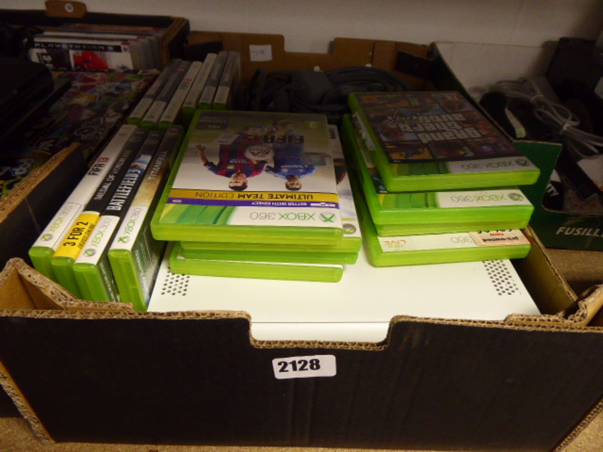 A Xbox 360 console with peripherals and various games