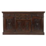 A Victorian oak sideboard with carved lion mask handles and an arrangement of four drawers and