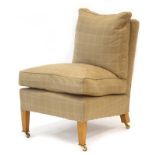 A contemporary 'Marlborough' lounge chair upholstered in caramel loosely chequered fabric,
