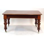 A Victorian mahogany library table on turned baluster legs with castors, w.