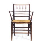 *Withdrawn* An Arts & Crafts ash spindle-framed 'Sussex' armchair with a rush seat,