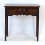 A Georgian mahogany and crossbanded lowboy with a single frieze drawer over a slightly shaped apron,