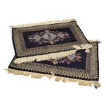A pair of 20th century Indian hand knotted rugs with blue grounds,