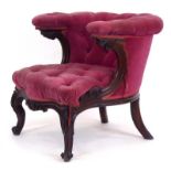 A 19th century rosewood and button upholstered armchair with foliate apron,