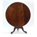 A Victorian mahogany tilt-top circular supper table on a turned support and three splayed legs with