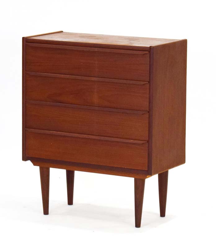 A 1960's teak chest of four drawers with turned handles on beech circular legs, of Danish design, w.