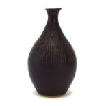 A Lucie Rie sgraffito vase of short bulbous form, the rim later repaired with a drip glaze,