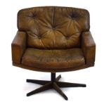 A 1970's brown leather button upholstered chair with a five-star swivel base
