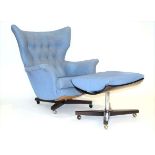 A 1960's G-Plan '6250' button upholstered armchair on a rosewood four-star base with castors,