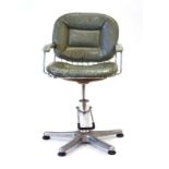 A 1970's aluminium and green vinyl barber's chair on an adjustable five-star base
