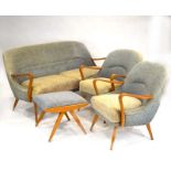 A 1960's beech and upholstered suite including a sofa, pair of armchairs and footstool,