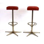A pair of 1960/70's stools with red vinyl patchwork seats and metalwork frames,
