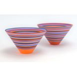 Sara Moorhouse, a near pair of bowls brightly decorated in orange with red, blue and black bands, d.