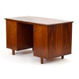 A 1960's Danish rosewood and crossbanded desk, the two doors each enclosing six graduated trays,