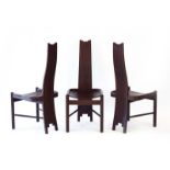 A set of three black ash staggered slat-back hall chairs,