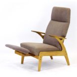 A 1960's Scandinavian oak and upholstered lounge armchair with an integral adjustable foot rest