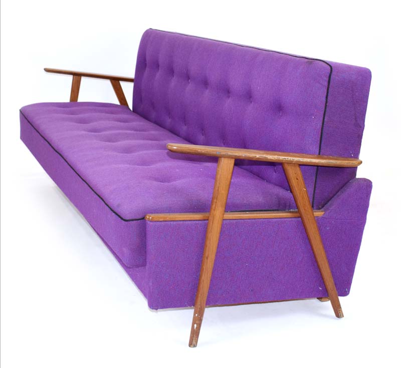 A 1960's Danish daybed with teak arms and purple woolen button upholstery