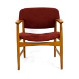 A 1960/70's Fritz Hansen oak elbow chair with blue fabric upholstery,