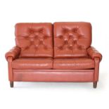 A 1970's Danish red leather and button upholstered highback two seater sofa