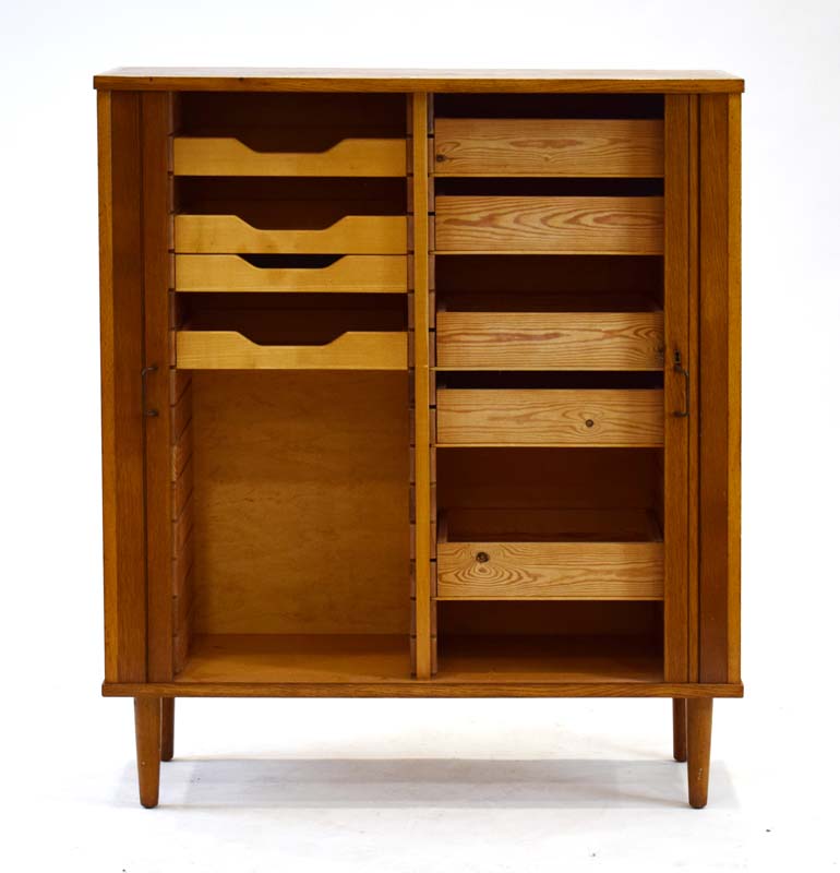A 1960's oak and crossbanded cabinet, the tambour doors enclosing nine drawers, on turned legs, w. - Image 2 of 2