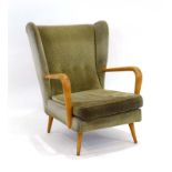 A 1950/60's beech framed and button upholstered wingback 'Bambino' armchair by Howard Keith