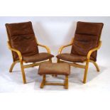 A pair of Stouby beech armchairs with loose brown leather seats,