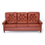 A 1970's Danish red leather and button upholstered highback three seater sofa