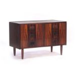 A 1960's Danish rosewood chest of six drawers with integral handles, on turned beech legs, w.